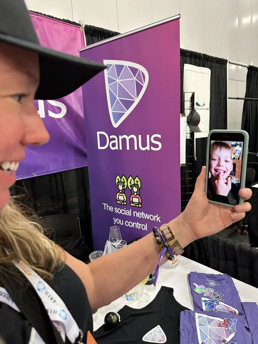 Members of the Damus team on a video call at the conference booth